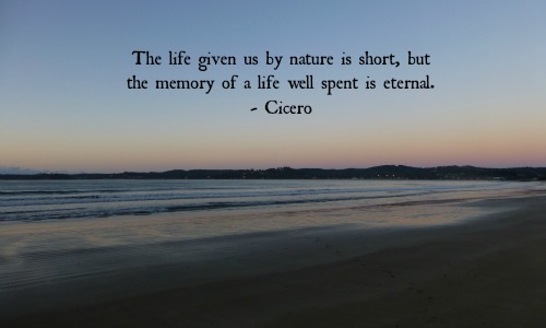 The life given us by nature is short, but the memory of a life well spent is eternal.  Cicero. Meme with seascape background.