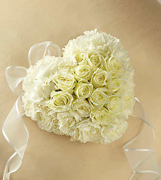 Small heart shaped casket adornment with cream roses