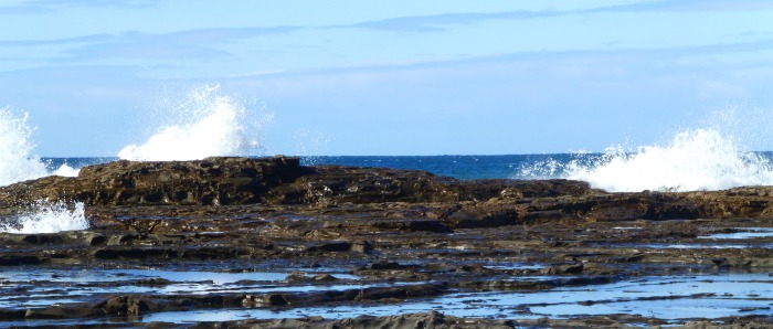 Waves hitting the rocks to illustrate the facts about suicide