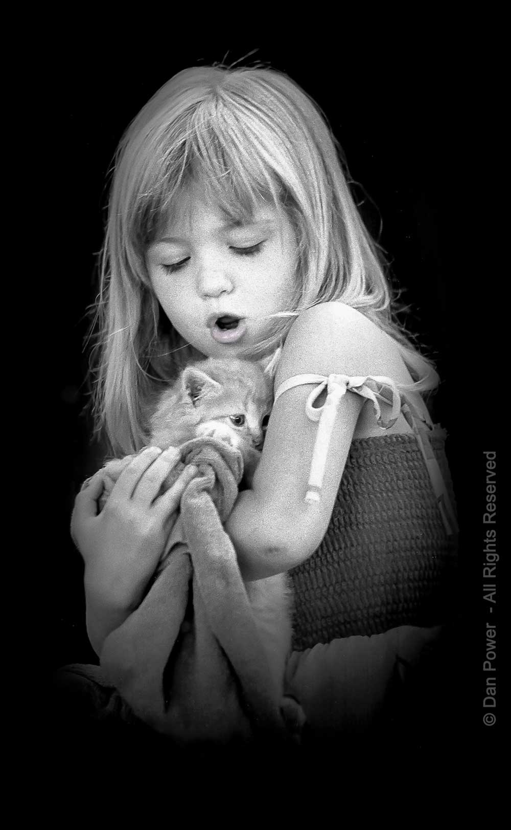 Young girl with kitten, black and white