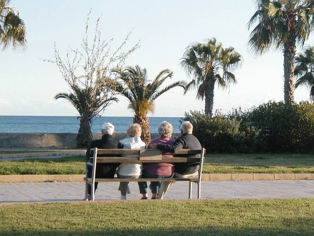 Two couples sitting on a bench to illustrate grief and jealousy of couples