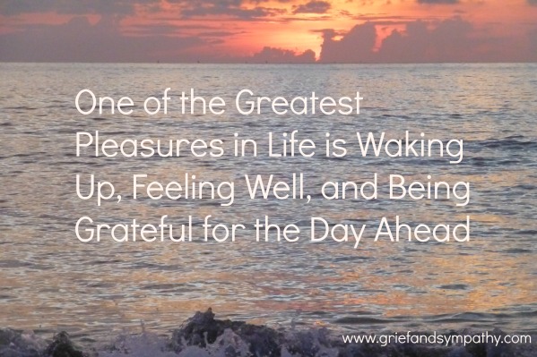 Sunrise over the sea with text: One of the Greatest Pleasures in Life is Waking Up, Feeling Well and Being Grateful for the Day Ahead.