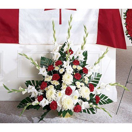 Red white and green military funeral flowers with flag