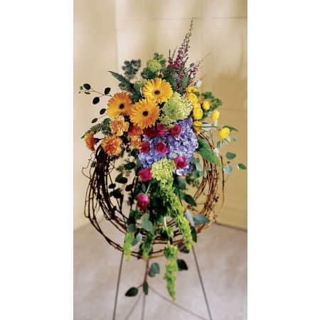 Rural inspired funeral standing spray with gerbera daisies and pink roses