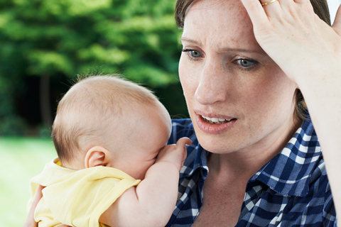 Woman with Baby looking like she can't remember something.