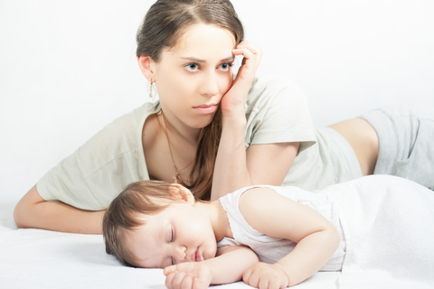 Sad woman with baby giving it up for adoption